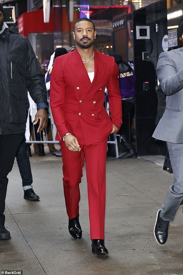 Man in a tailored red suit at a formal event
